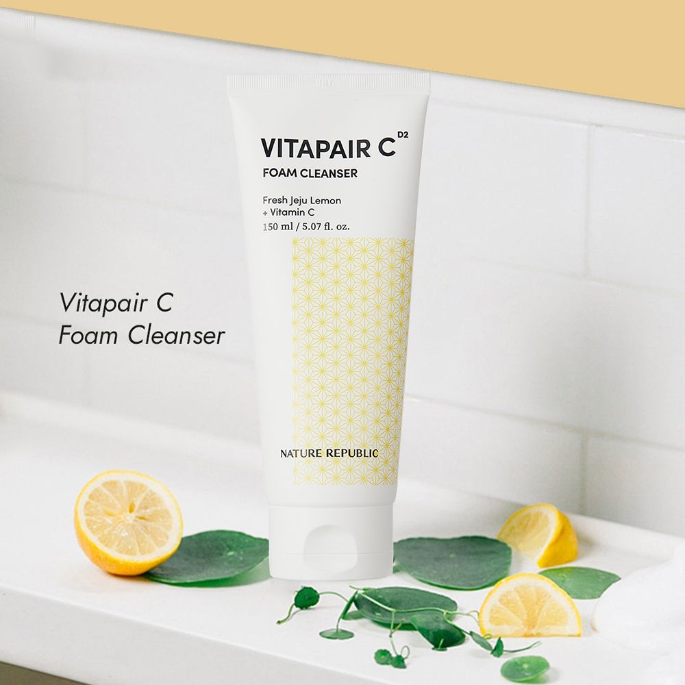 Tube blanc de Vitapair C Foam Cleanser. Sur une surface blanche avec citrons et feuilles. Texte: NATURE REPUBLIC, VITAPAIR C.