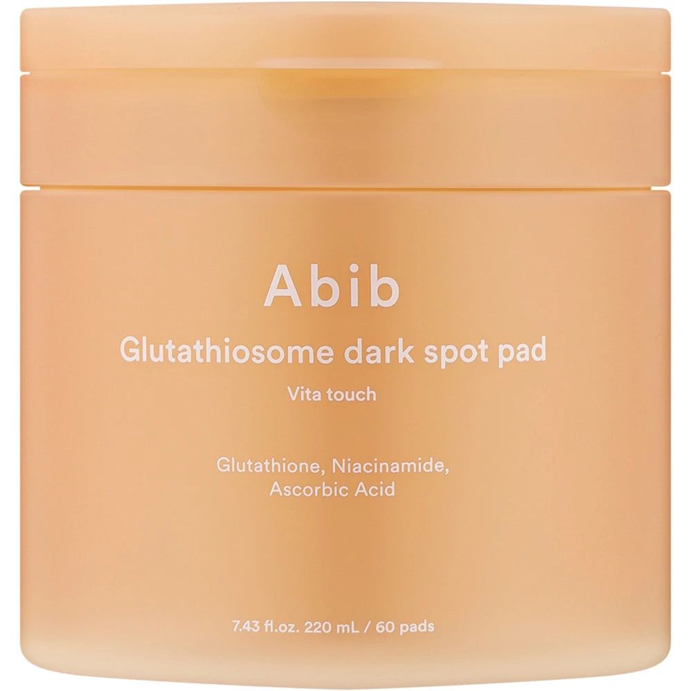 Beige pot met deksel. Opschrift: Abib Glutathiosome dark spot pad. Tekst: Vita touch. Ingrediënten: Glutathion, Niacinamide, Ascorbinezuur.