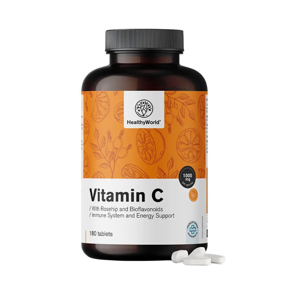 Bruine fles met vitamine C-tabletten. Opschrift: HealthyWorld, Vitamin C 1000 mg, 180 tabletten. Enkele tabletten ernaast.