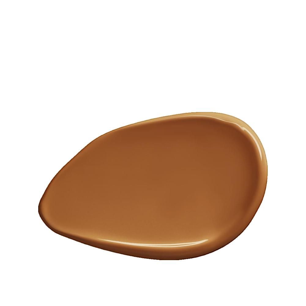 Vlek van huidskleurige foundation. De textuur is glad en glanzend. De kleur is een warme, donkere bruintint.