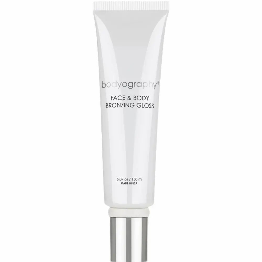 Witte tube met zilveren dop. Opschrift: BODYOGRAPHY FACE & BODY BRONZING GLOSS. Inhoud: 5.07 oz / 150 ml.