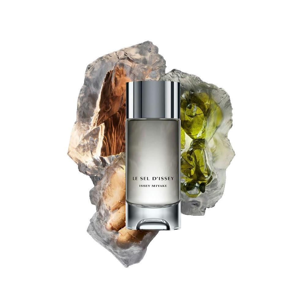Flacon de parfum avec bouchon argenté, entouré de pierres et d'éléments verts. Inscription : LE SEL D'ISSEY, ISSEY MIYAKE.
