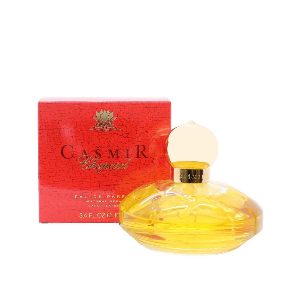 Geel parfumflesje met gouden dop en rode verpakking. Opschrift: Casmir Chopard.