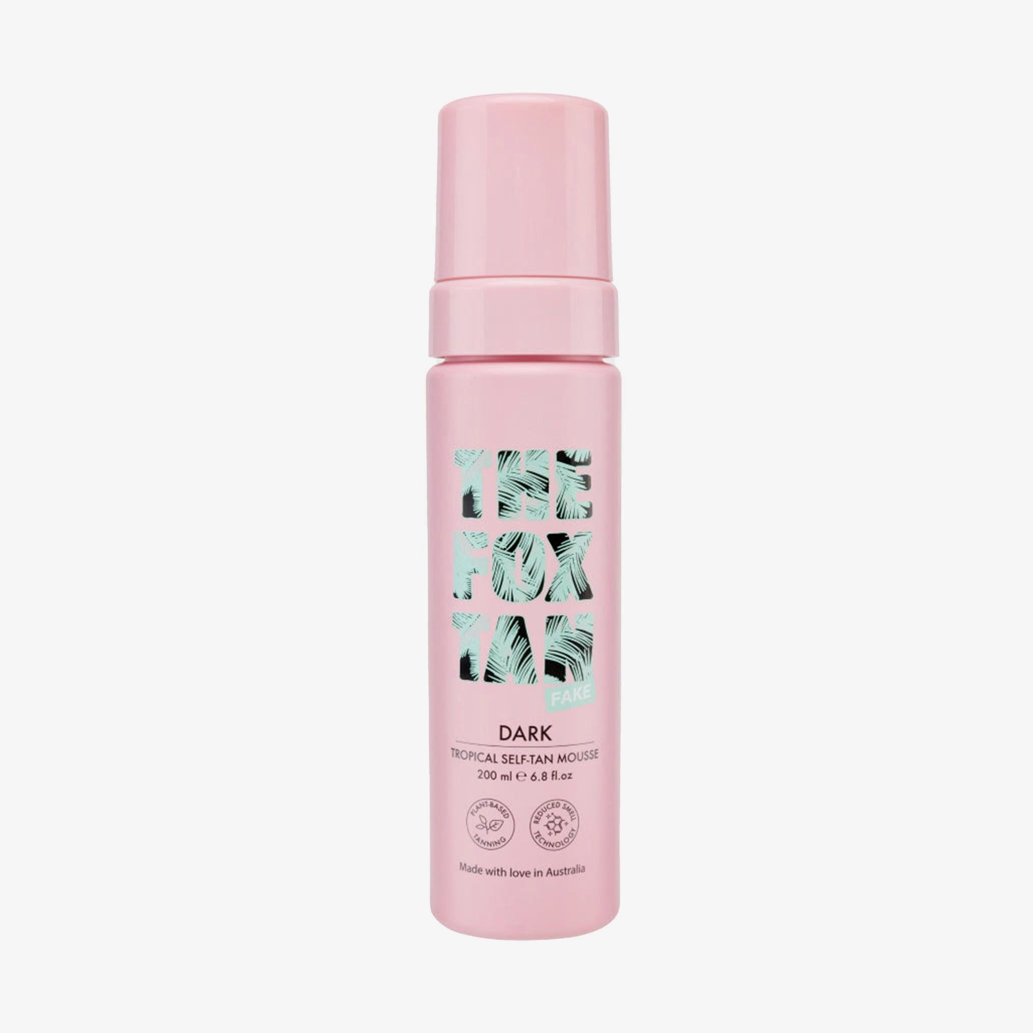 Flacon rose THE FOX TAN DARK Tropical Self-Tan Mousse. Certifications visibles.