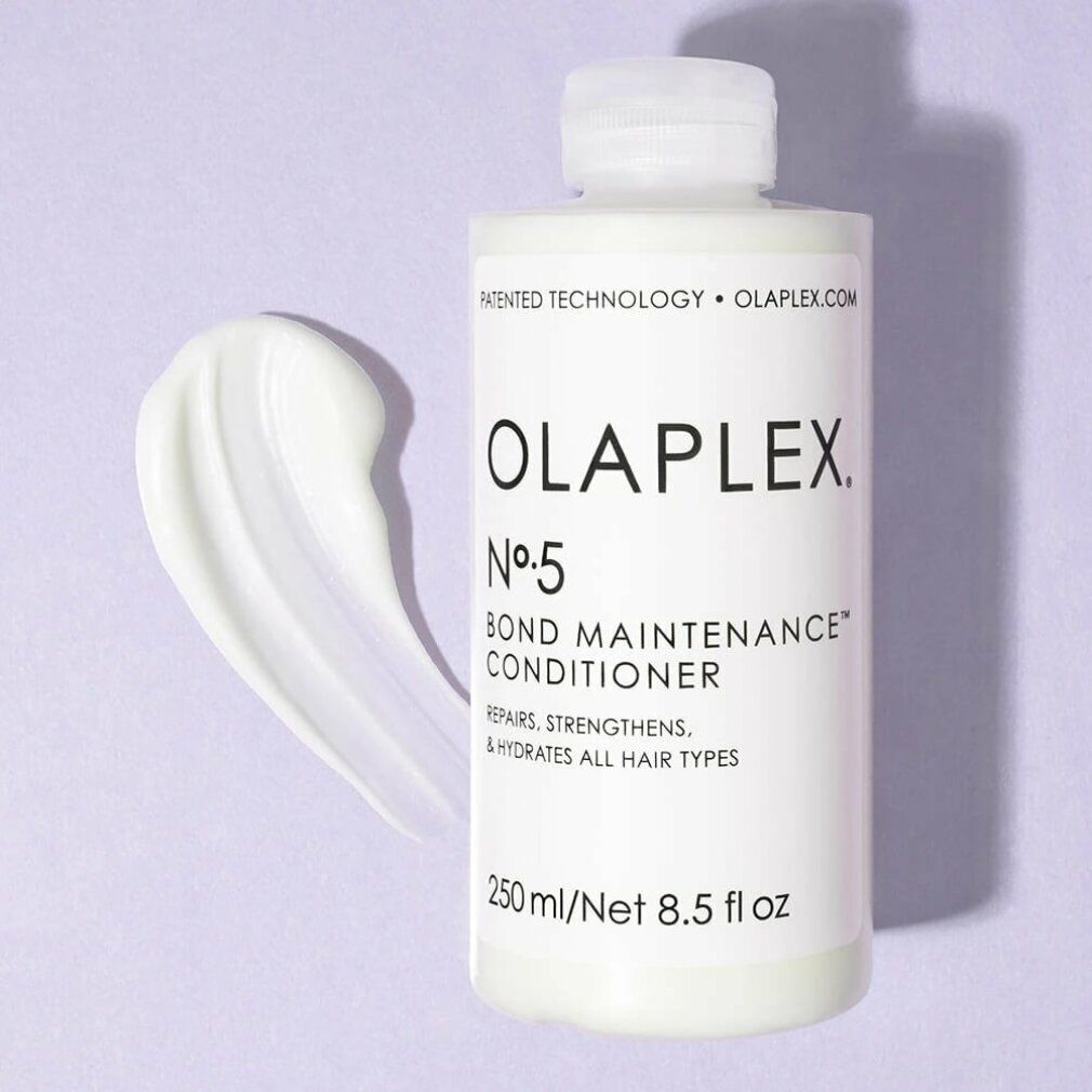 Flacon blanc Olaplex Nº5 Bond Maintenance Conditioner avec substance crémeuse à côté. Contient 250 ml/8,5 fl oz. Répare, renforce et hydrate.