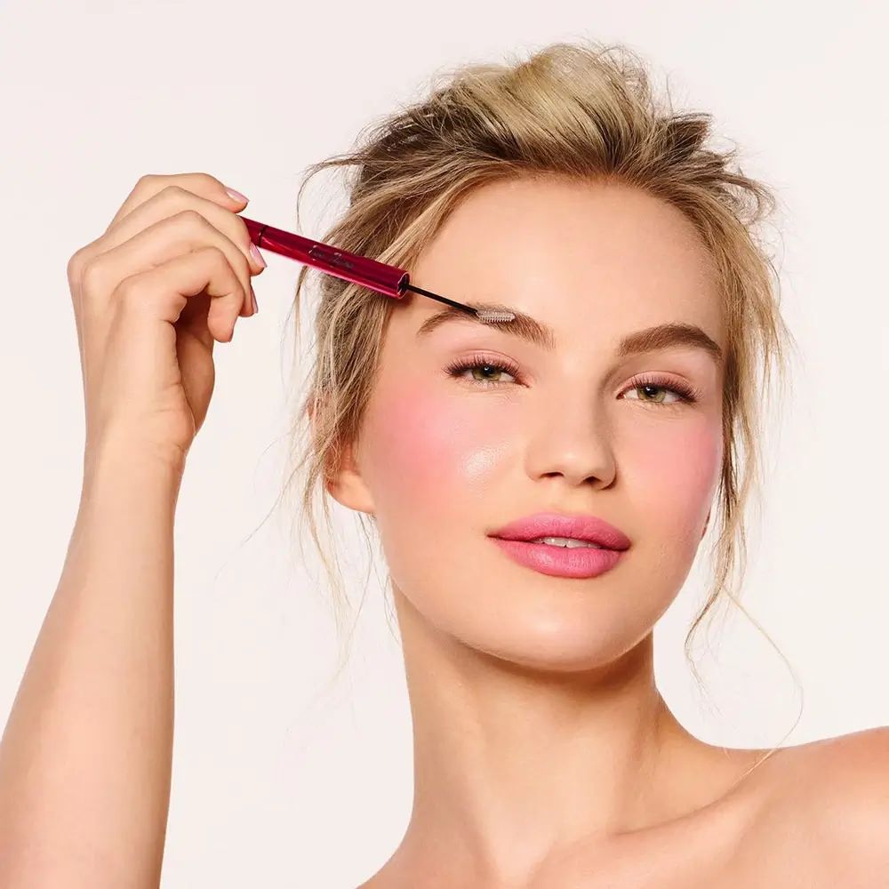 Vrouw met roze pen op oog. Pen: Bodyography Epic Brow. Vrouw draagt make-up.