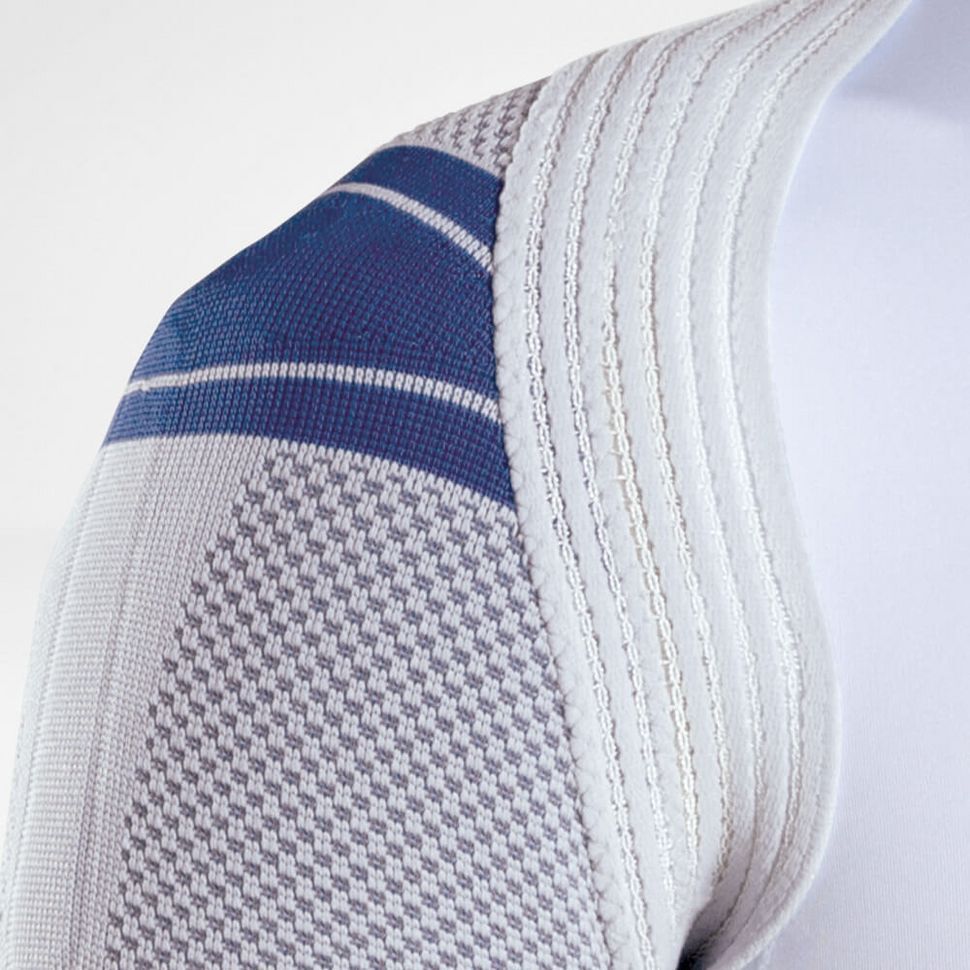 Schouderbrace, grijs-blauw gebreide stof, ribstructuur, close-up. Blauwe strepen op de schouder.