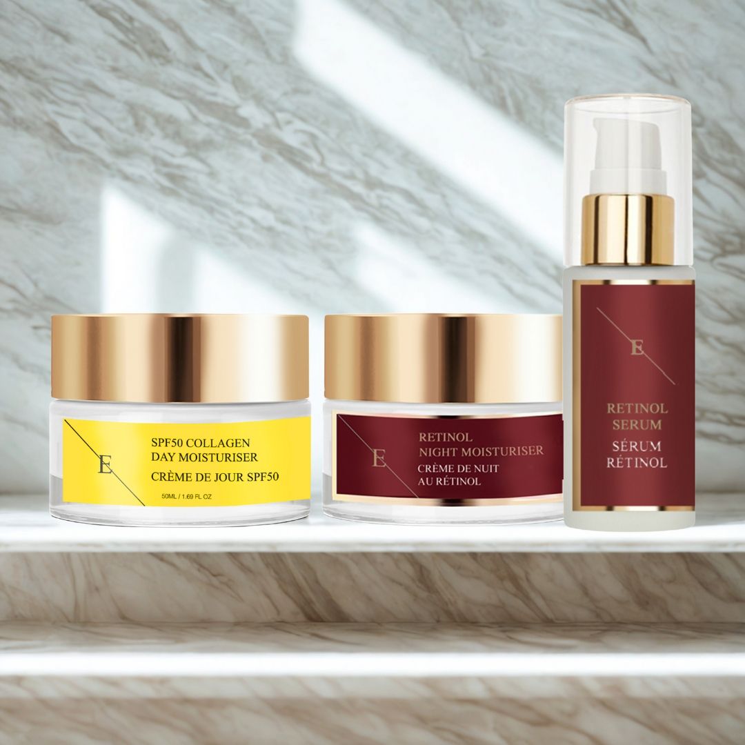 Trois produits cosmétiques : crème de jour, crème de nuit et sérum. Couvercles dorés, étiquettes avec texte. Inscription : Sérum Rétinol, Crème de jour SPF50.