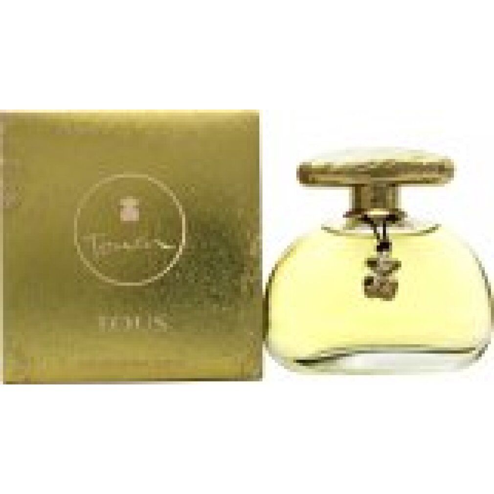 Flacon de parfum à côté d'une boîte dorée. 'Tous' est écrit sur la boîte. Le flacon a un bouchon doré.