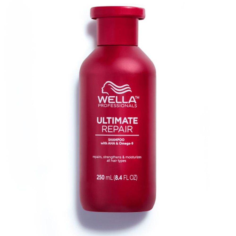 Flacon de shampooing rouge avec étiquette blanche. Inscription: Wella Professionals Ultimate Repair Shampoo. 250 ml.