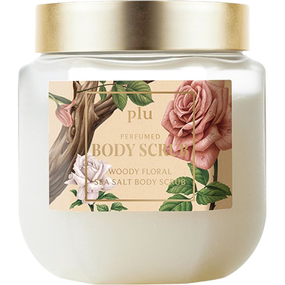 Pot en verre avec couvercle doré. Étiquette avec motif floral et nom du produit : PLU Perfumed Body Scrub.