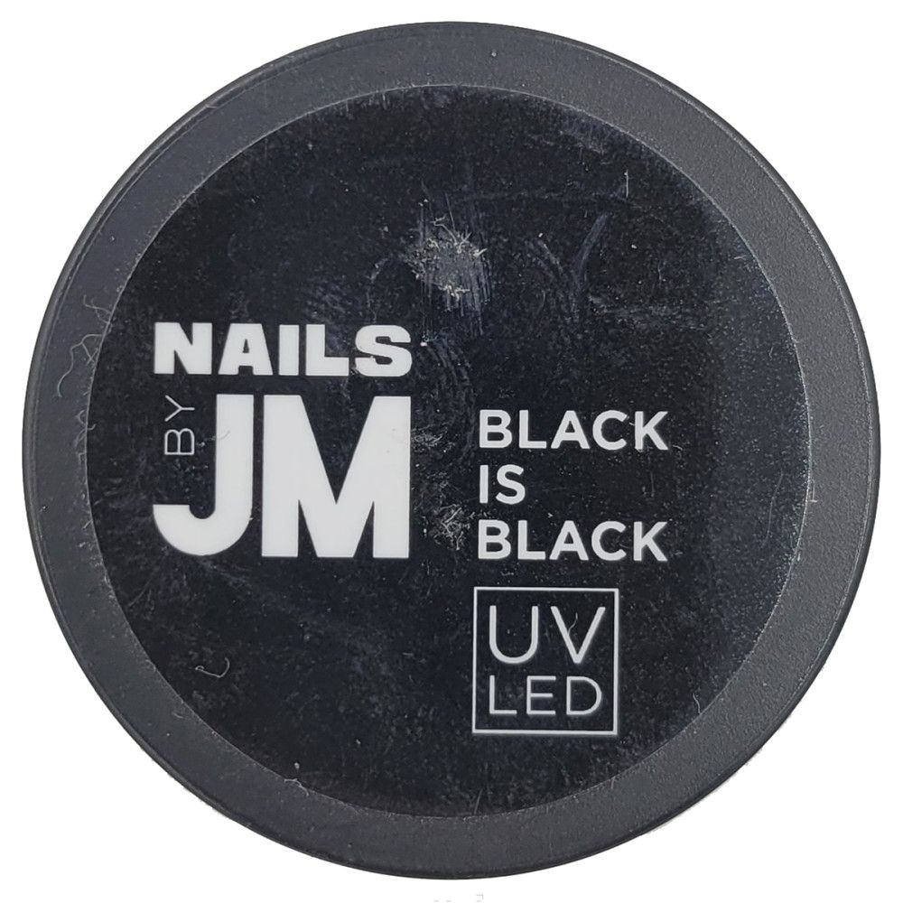 Pot noir rond. Inscription : NAILS BY JM, BLACK IS BLACK, UV LED.