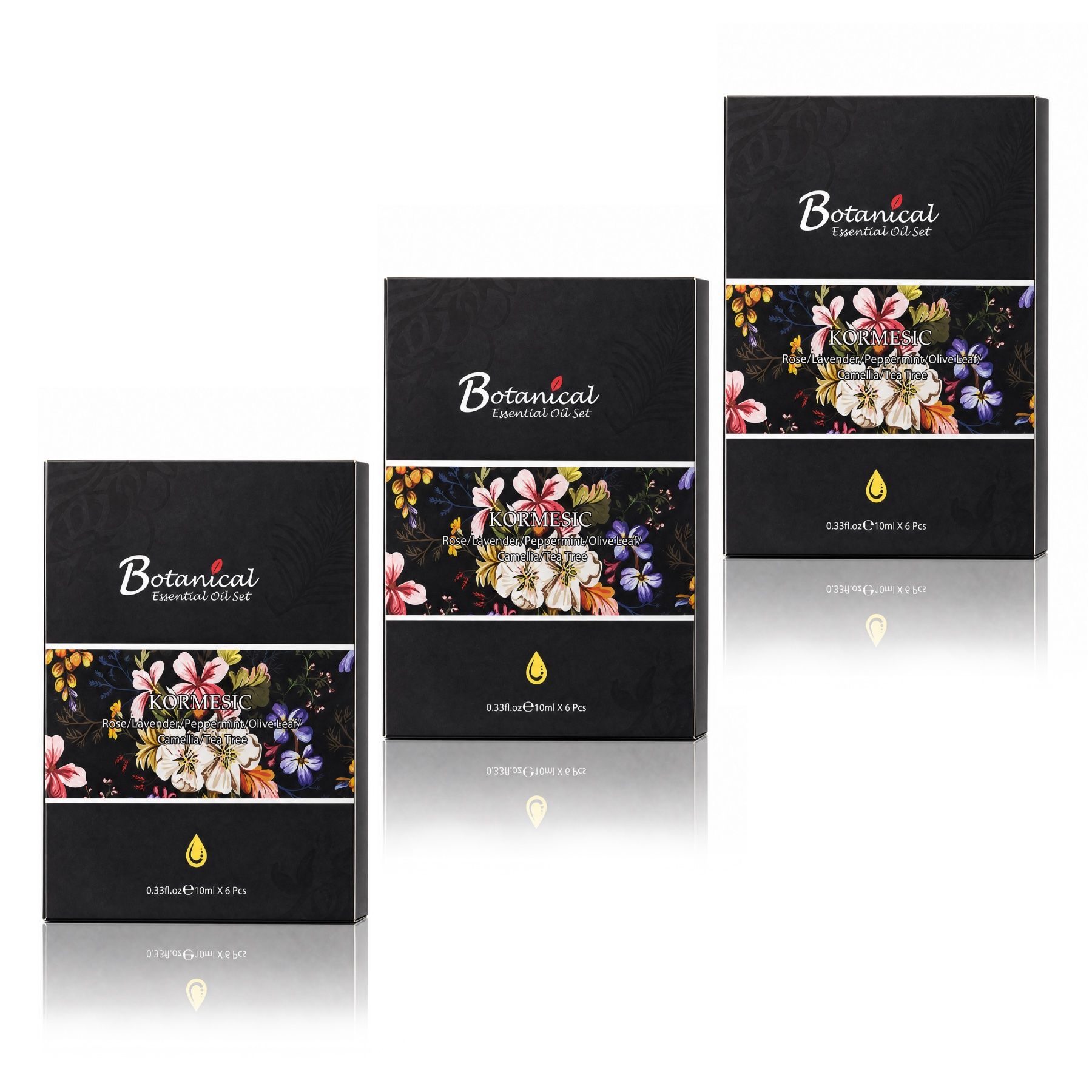 Trois boîtes noires pour huiles essentielles avec motif floral et inscription 'Botanical Essential Oil Set'.