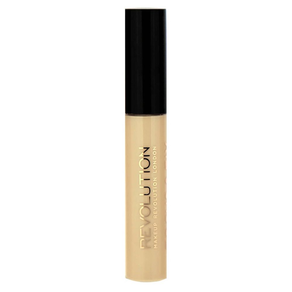 Un correcteur liquide dans un flacon transparent avec un capuchon noir. Inscription dorée "REVOLUTION MAKEUP REVOLUTION LONDON".