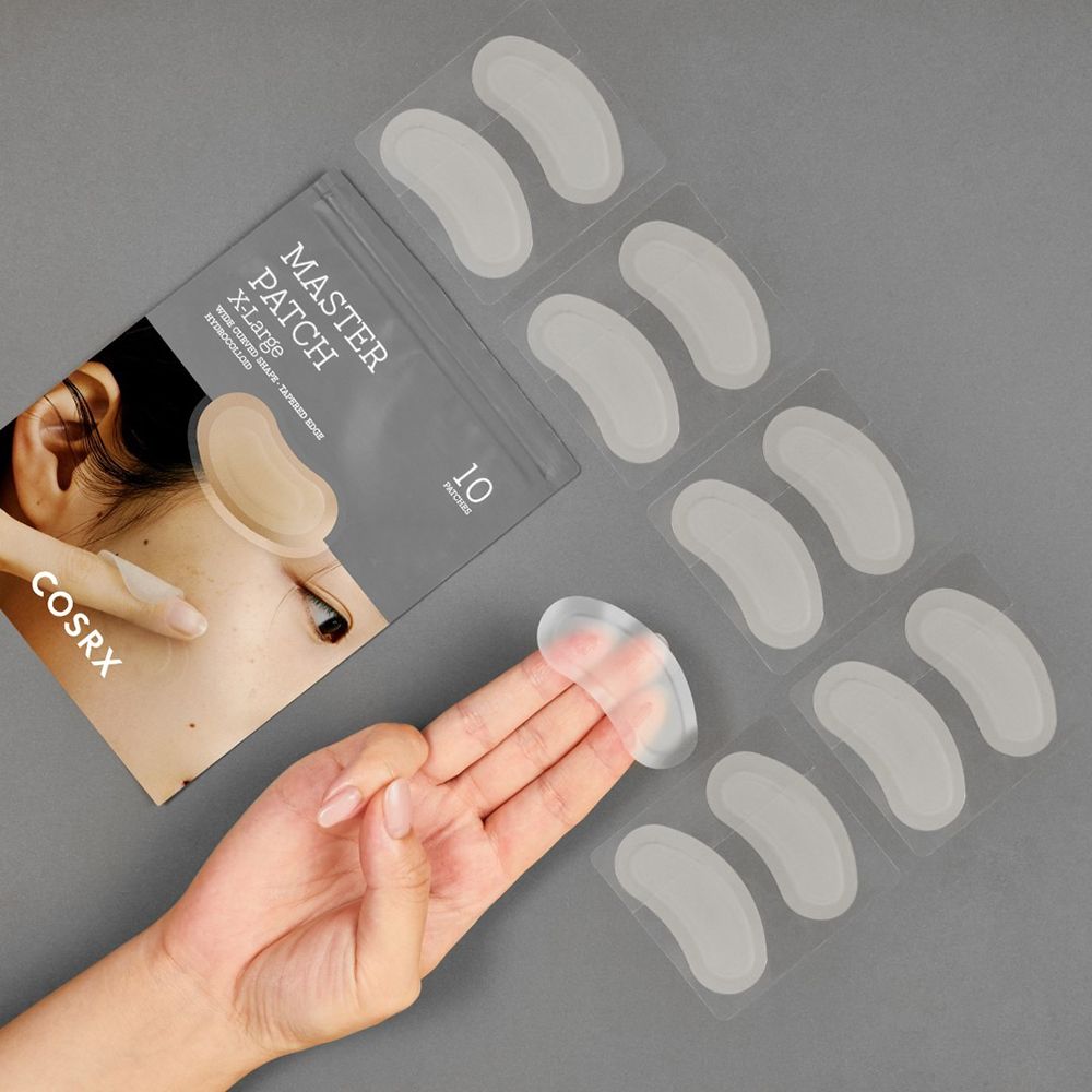 Paquet de patchs anti-acné et patchs individuels. Sur le paquet : MASTER PATCH X-Large. Les patchs sont transparents.