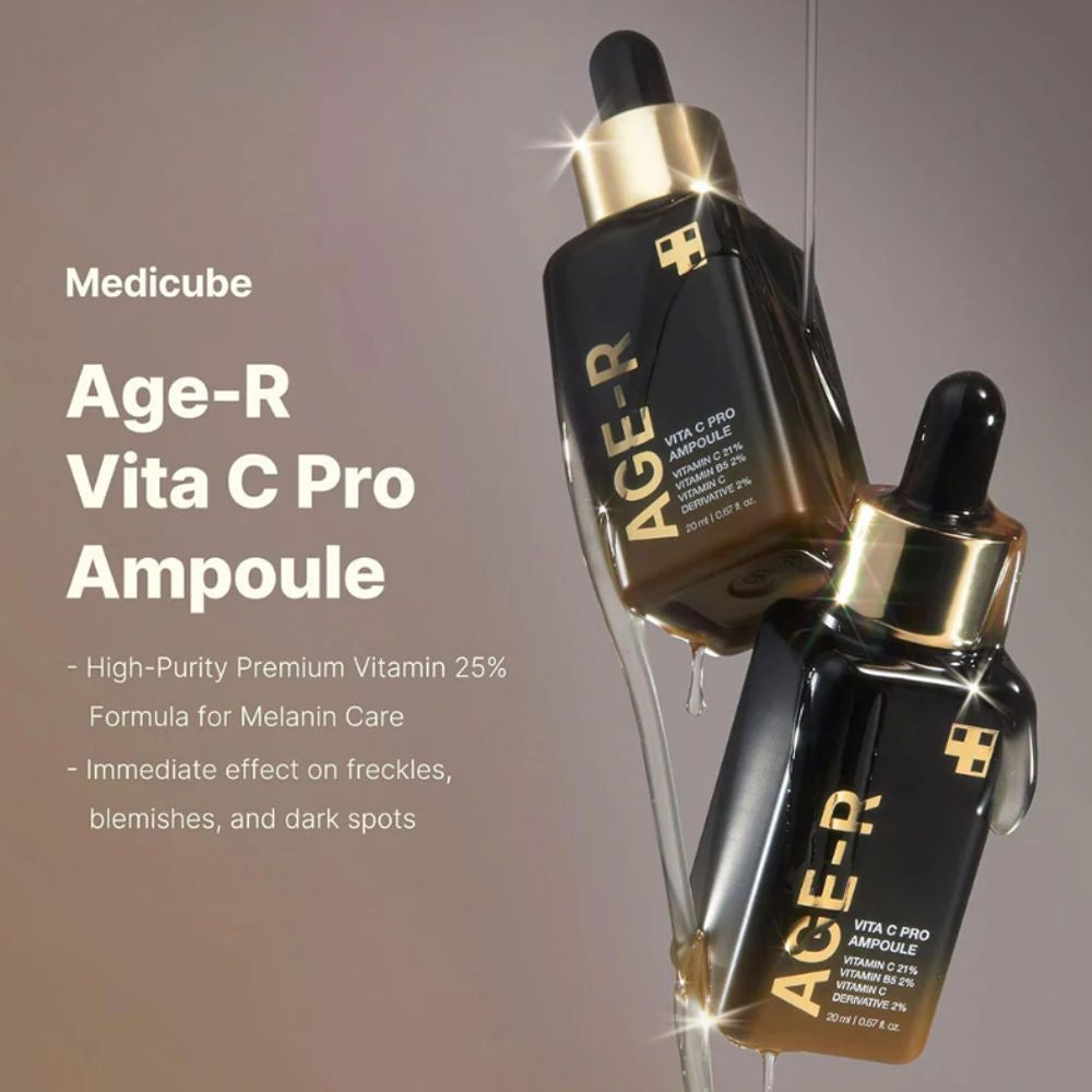 Deux flacons Age-R Vita C Pro Ampoule. Flacons noirs avec bouchons dorés. Des gouttes coulent. Texte : Age-R, Vita C Pro.