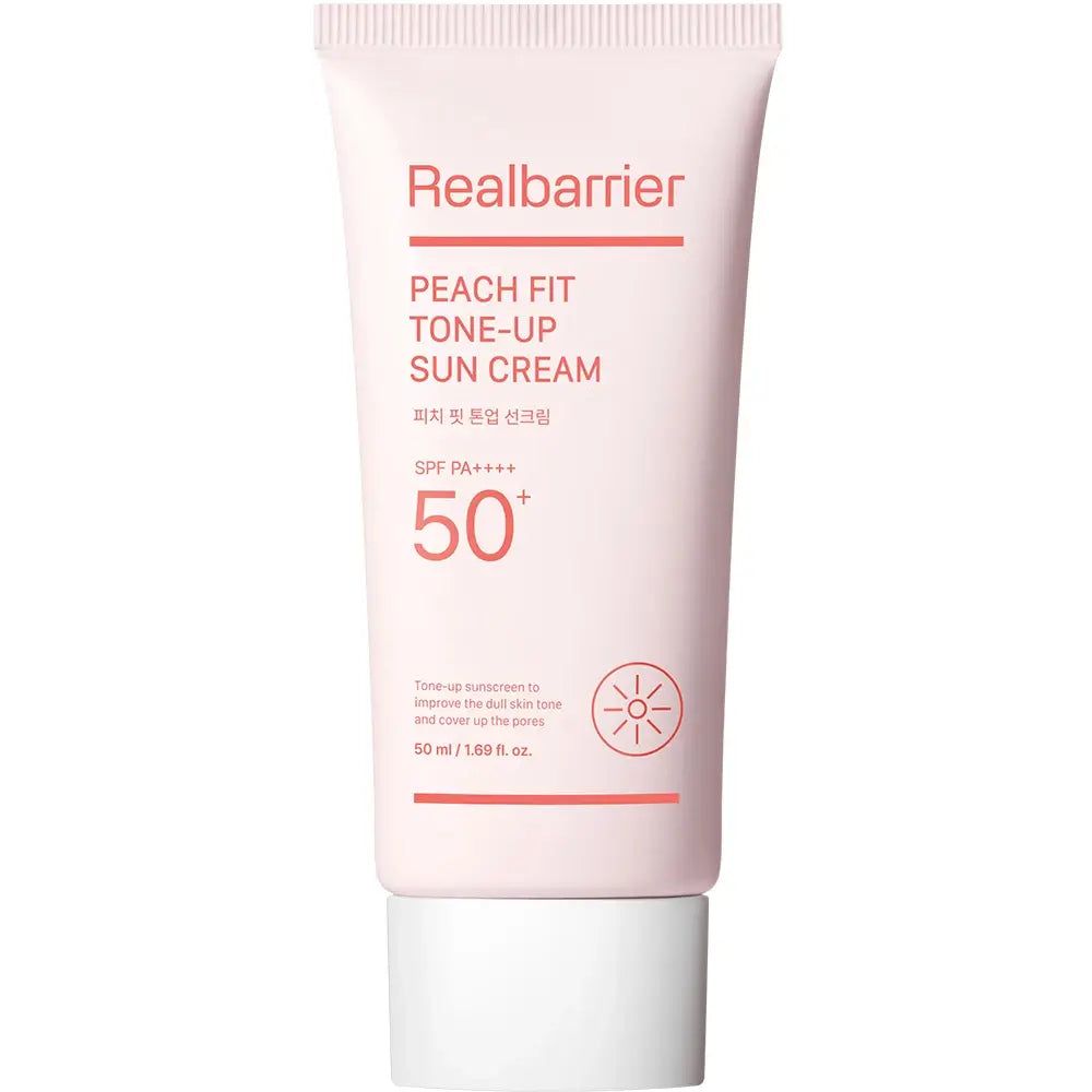 Tube rose avec bouchon blanc. Inscription: Realbarrier Peach Fit Tone-Up Sun Cream SPF 50+ PA++++. Symbole de soleil.