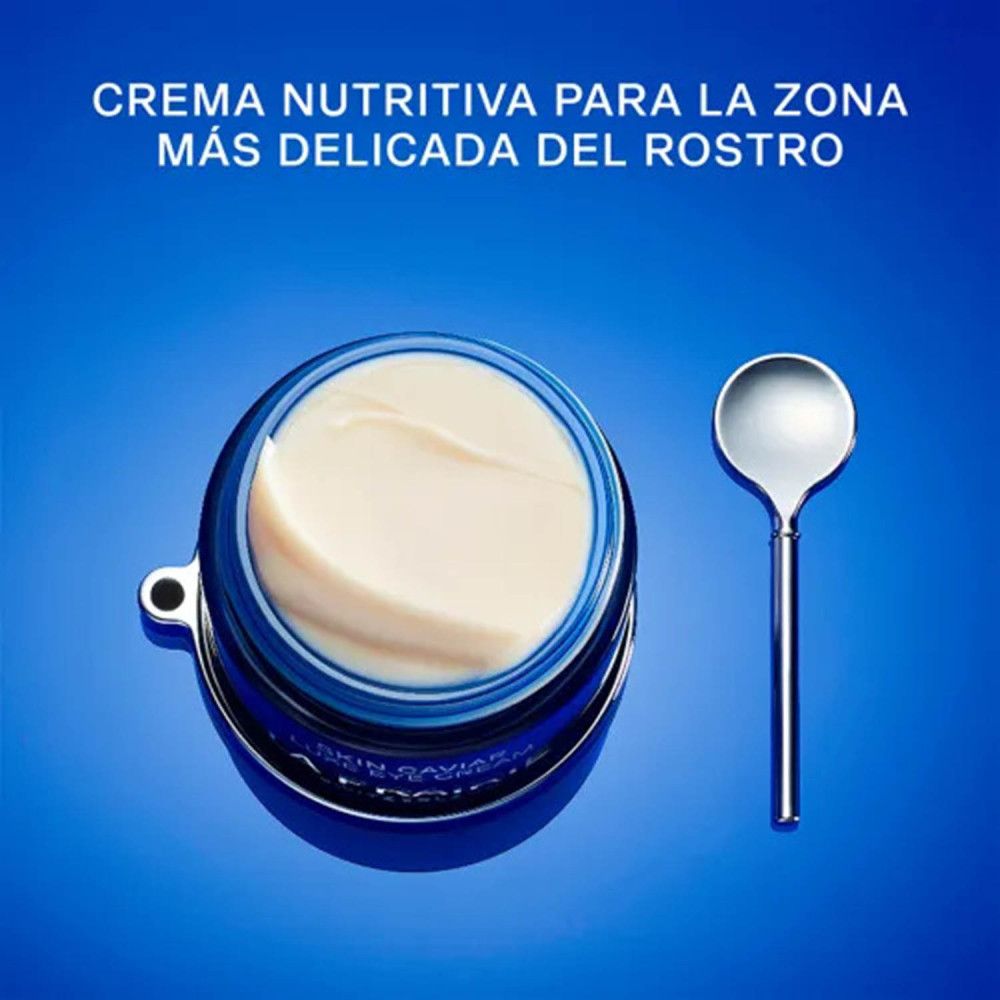 Open blauwe pot met crème en spatel. Opschrift: Skin Caviar Luxe Eye Cream, La Prairie, Switzerland.