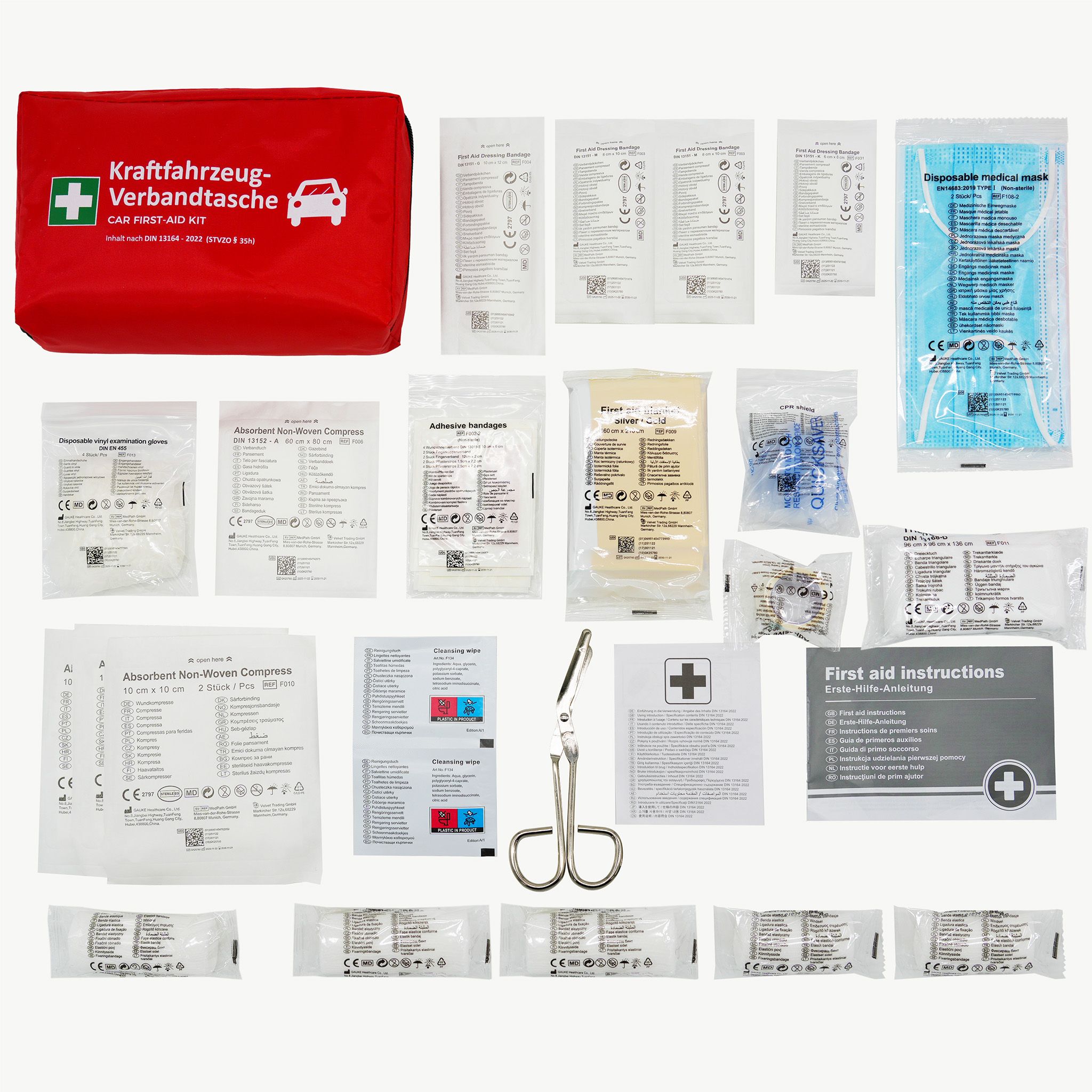Trousse de premiers secours ouverte avec fournitures. Contient bandages, masques, gants, ciseaux, instructions.