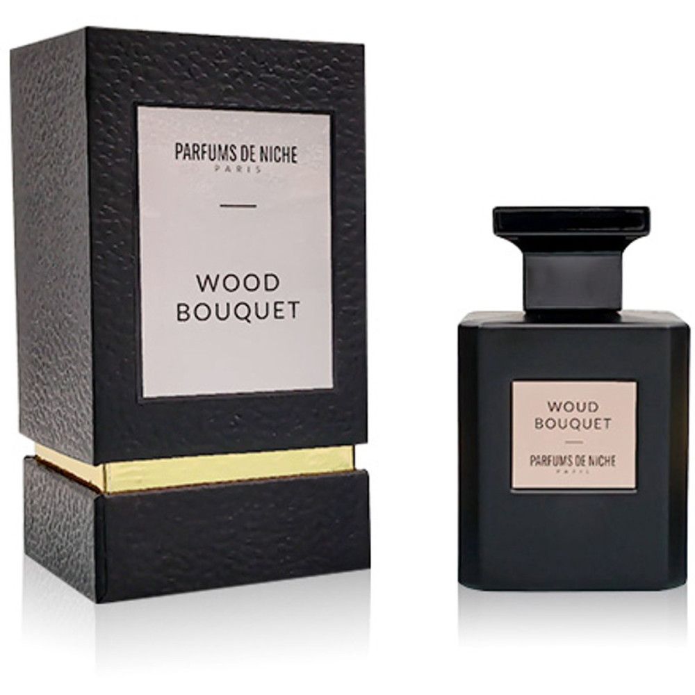 Zwarte parfumfles en de bijbehorende verpakkingsdoos. Beide dragen het etiket "WOUD BOUQUET PARFUMS DE NICHE PARIS".