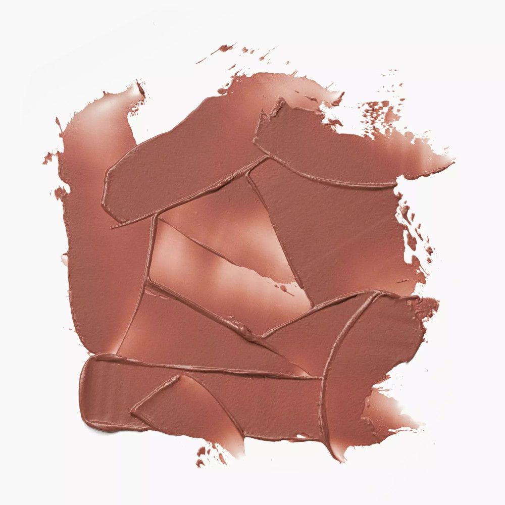 Nuance de baume à lèvres clair sur fond blanc. Texture avec coups de pinceau.