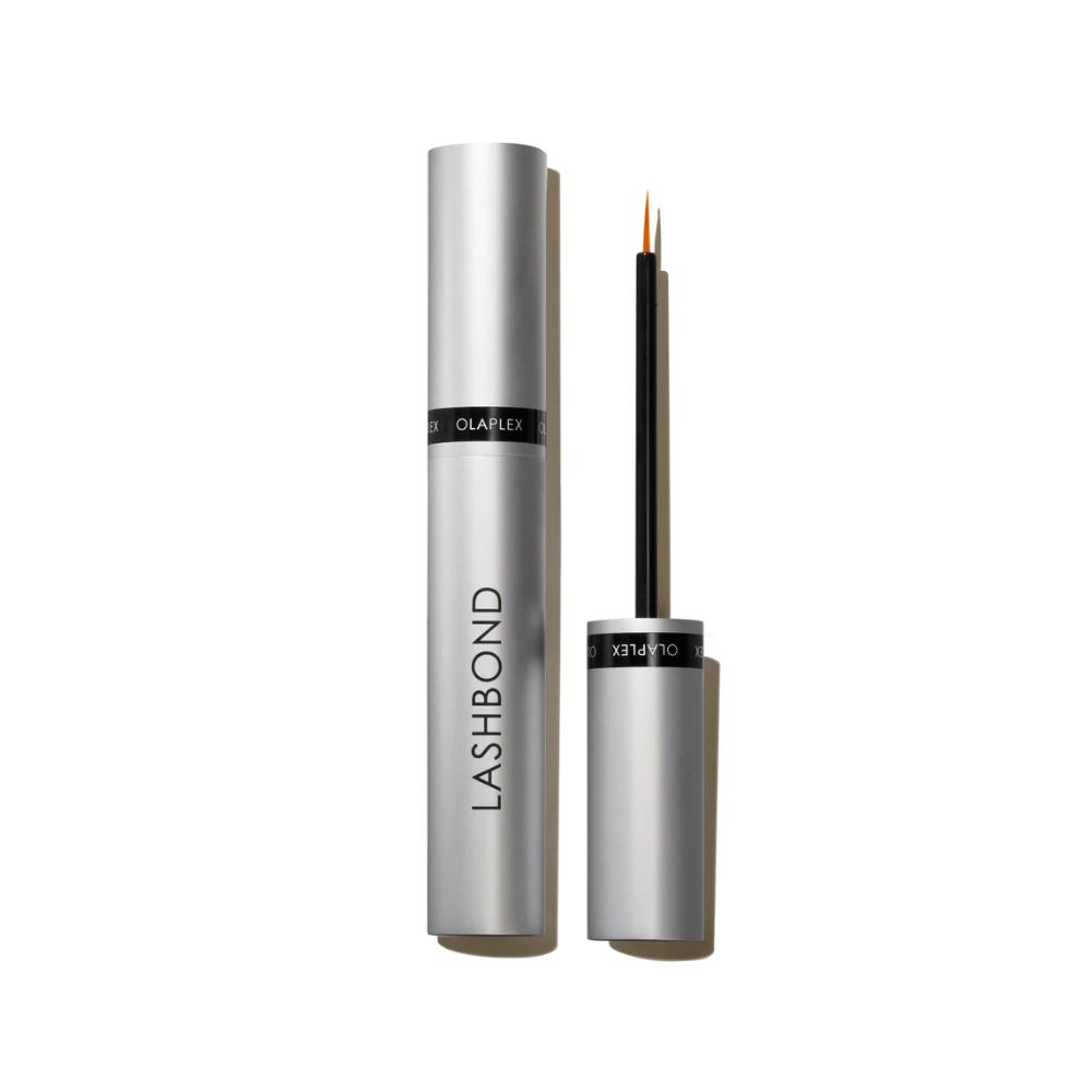 Tube argentée et applicateur. "LASHBOND" est écrit sur la tube. L'applicateur a une pointe fine.