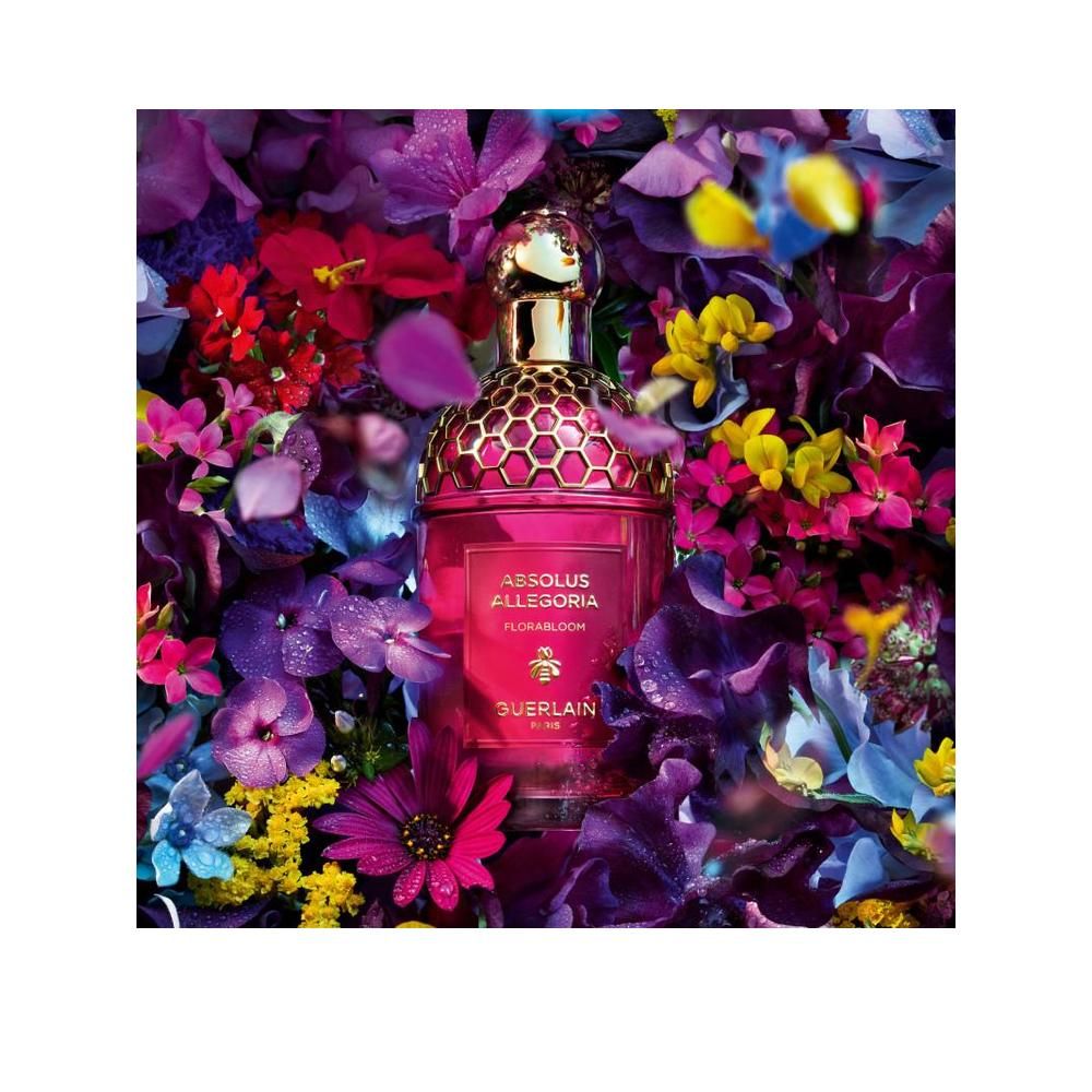 Parfumfles in bloemstuk. Opschrift: Absolus Allegoria Florabloom, Guerlain Paris. Gouden dop.