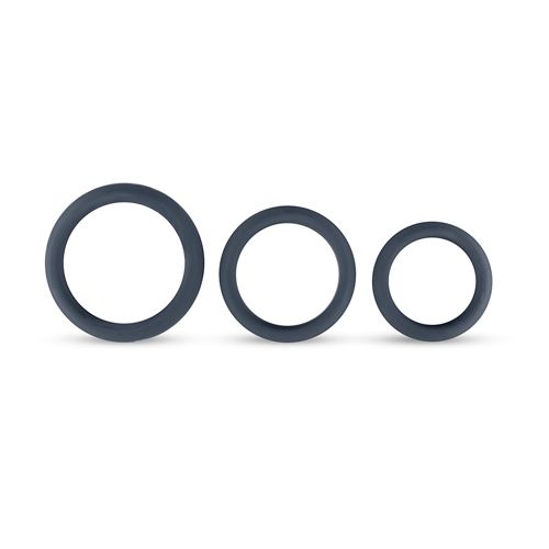 Drie grijze penisringen van siliconen in verschillende maten. Ringen zijn rond.