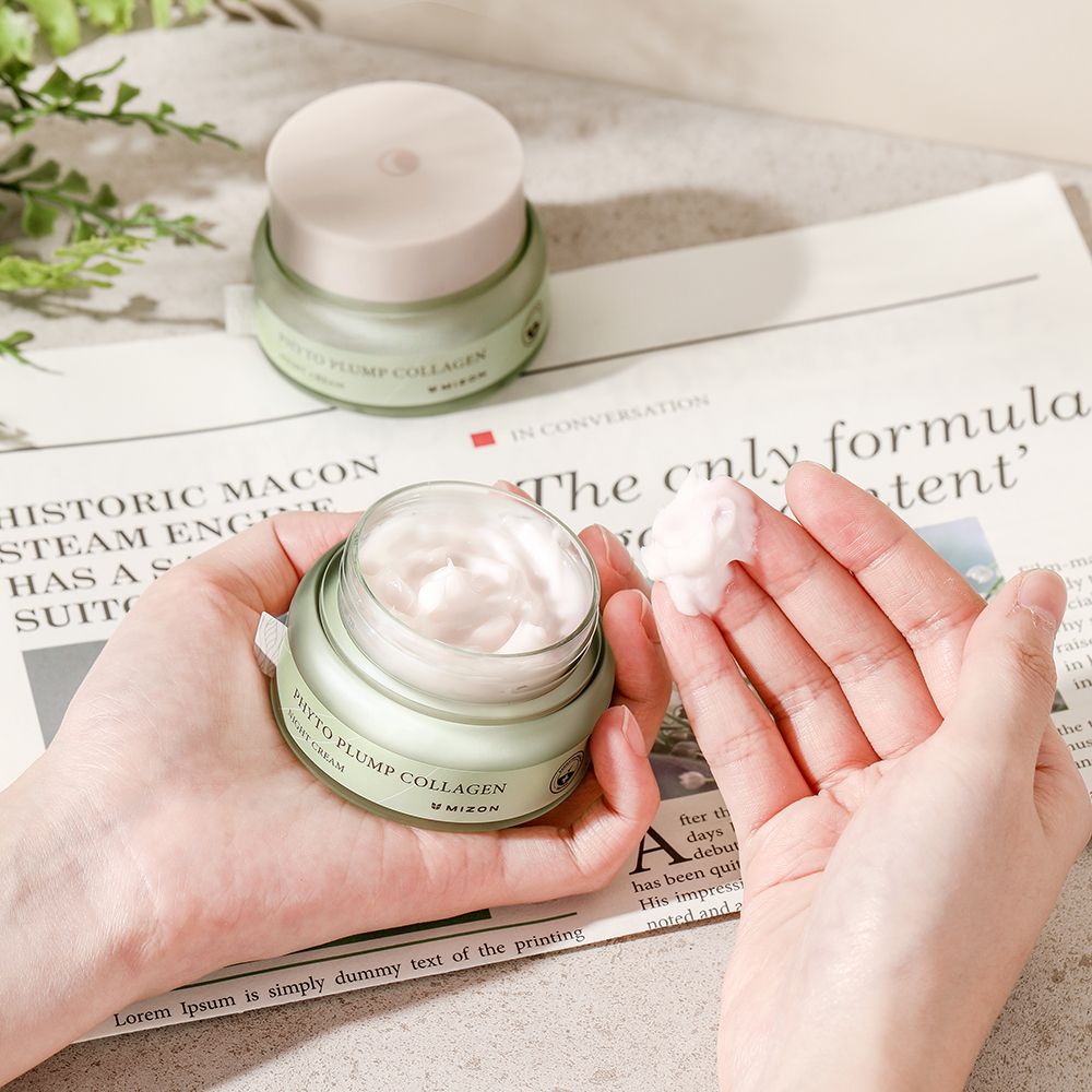 Handen houden een open potje met crème vast. Daarnaast nog een potje en een krant.