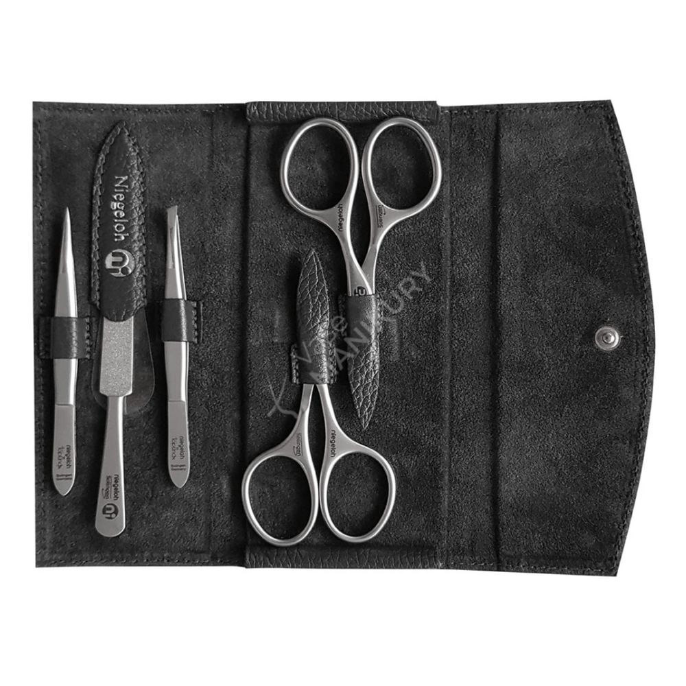 Niegeloh Solingen etui met manicure-instrumenten: nagelriemschaartje, nagelschaartje, pincet, nagelvijl en nagelriemstokje.
