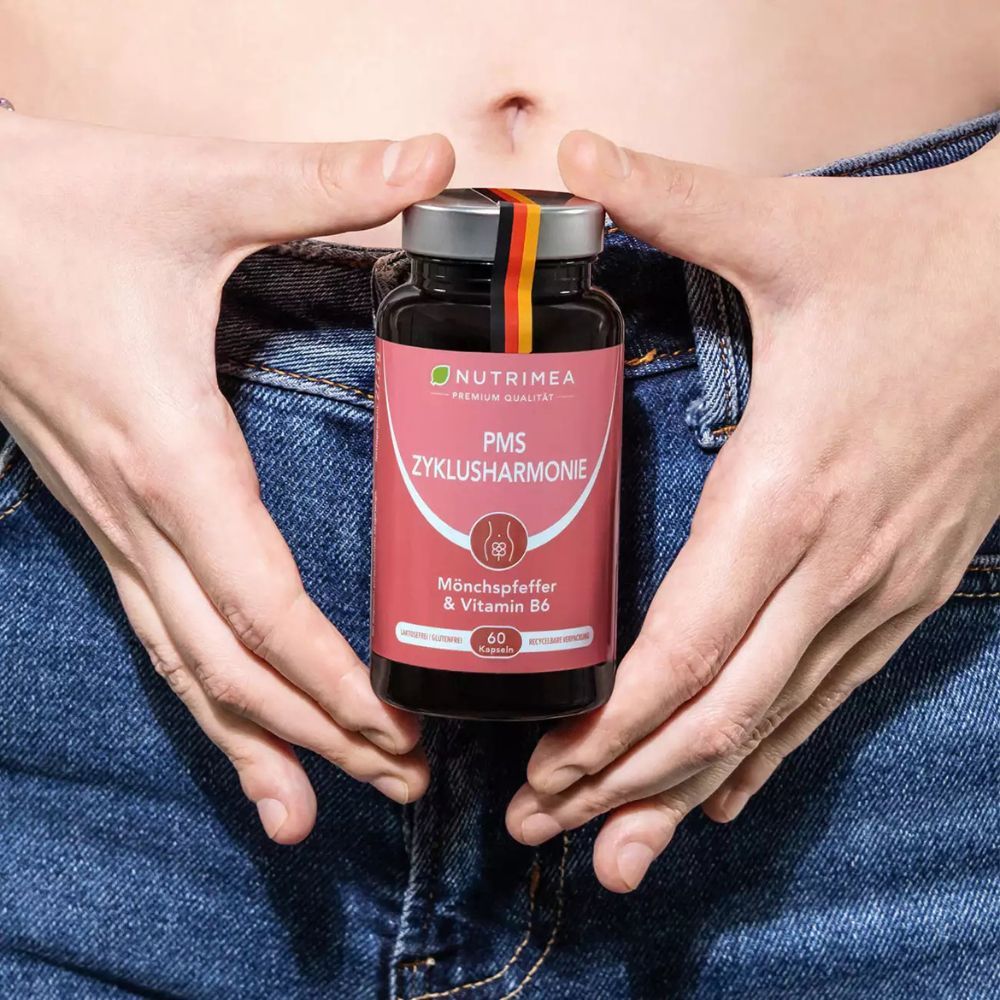 Handen houden productfles. Opschrift: PMS Zyklus Harmonie. 60 capsules.