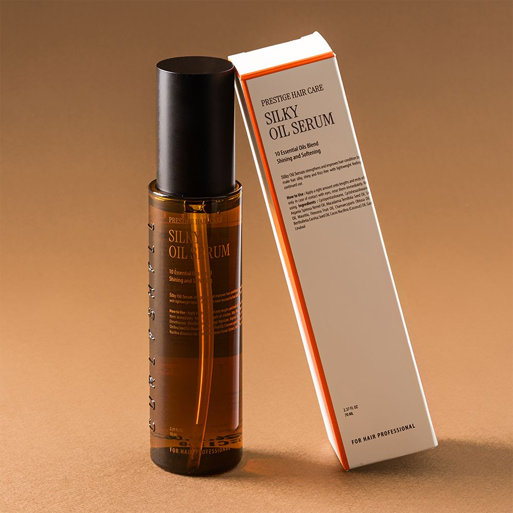 Bruine haaroliefles en verpakking. Opschrift: Silky Oil Serum. Voor professionele haarverzorging.