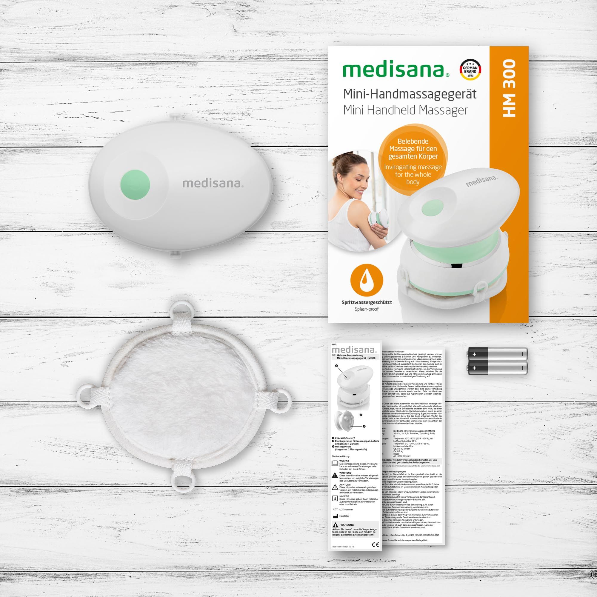 Medisana HM 300 mini handmassager en meegeleverde accessoires.
