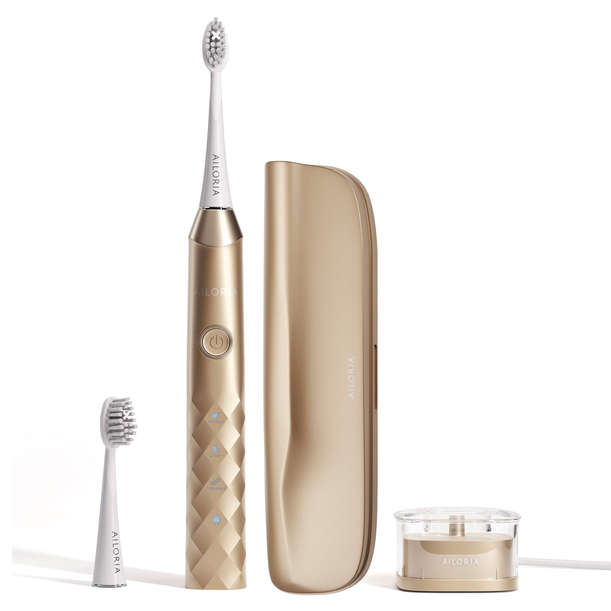 Brosse à dents sonique dorée avec accessoires : tête, étui, socle de charge. Logo AILORIA visible.