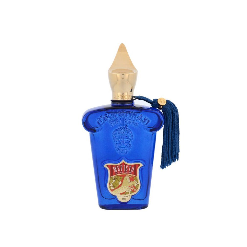 Flacon bleu avec bouchon doré et pompon. Inscription Mefisto. Flacon avec détails en relief.
