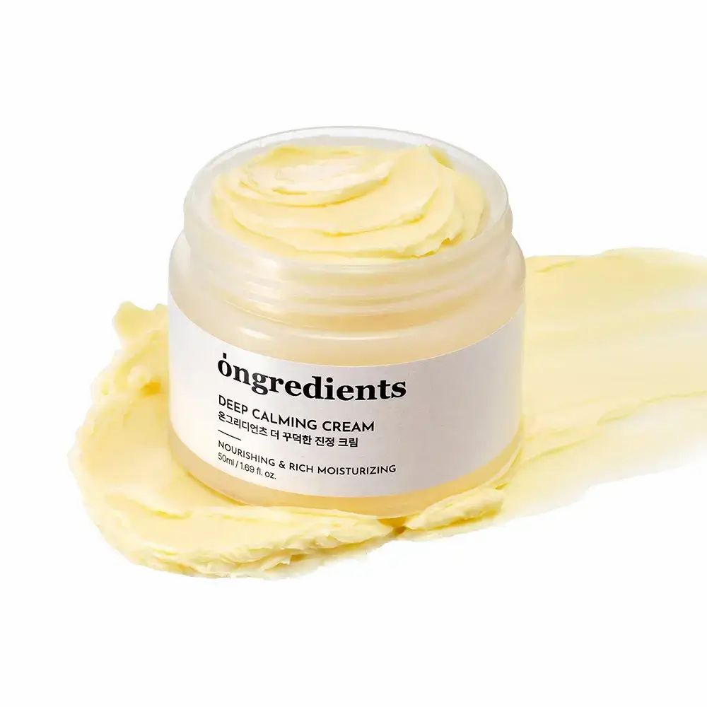 Open crèmepot met crème. Opschrift: Ongredients, Deep Calming Cream, Koreaanse tekst, Nourishing & Rich Moisturizing. Crèmevlek.