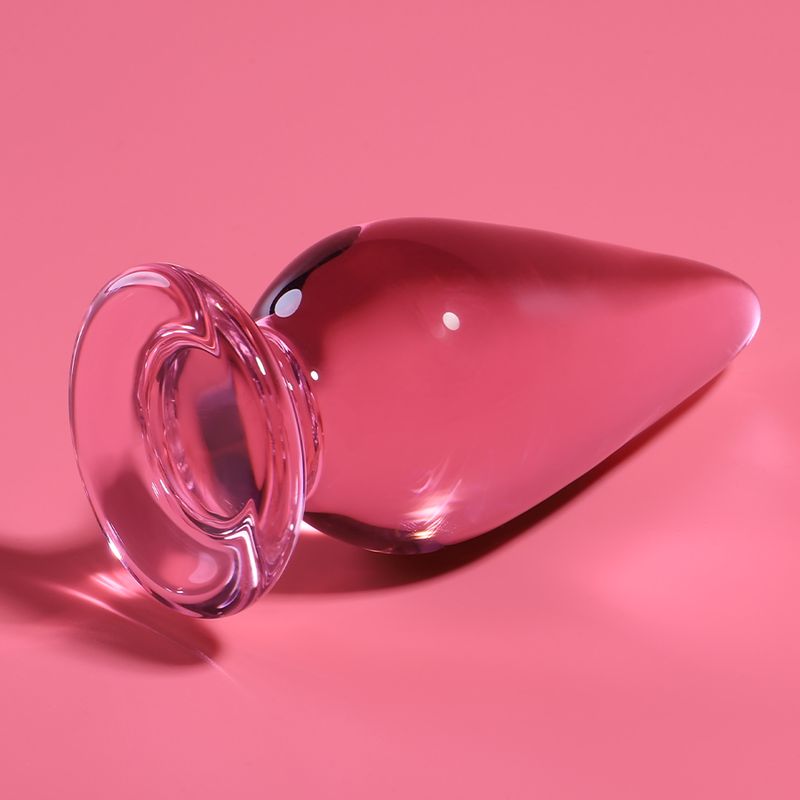 Plug anal en verre rose avec une large base.