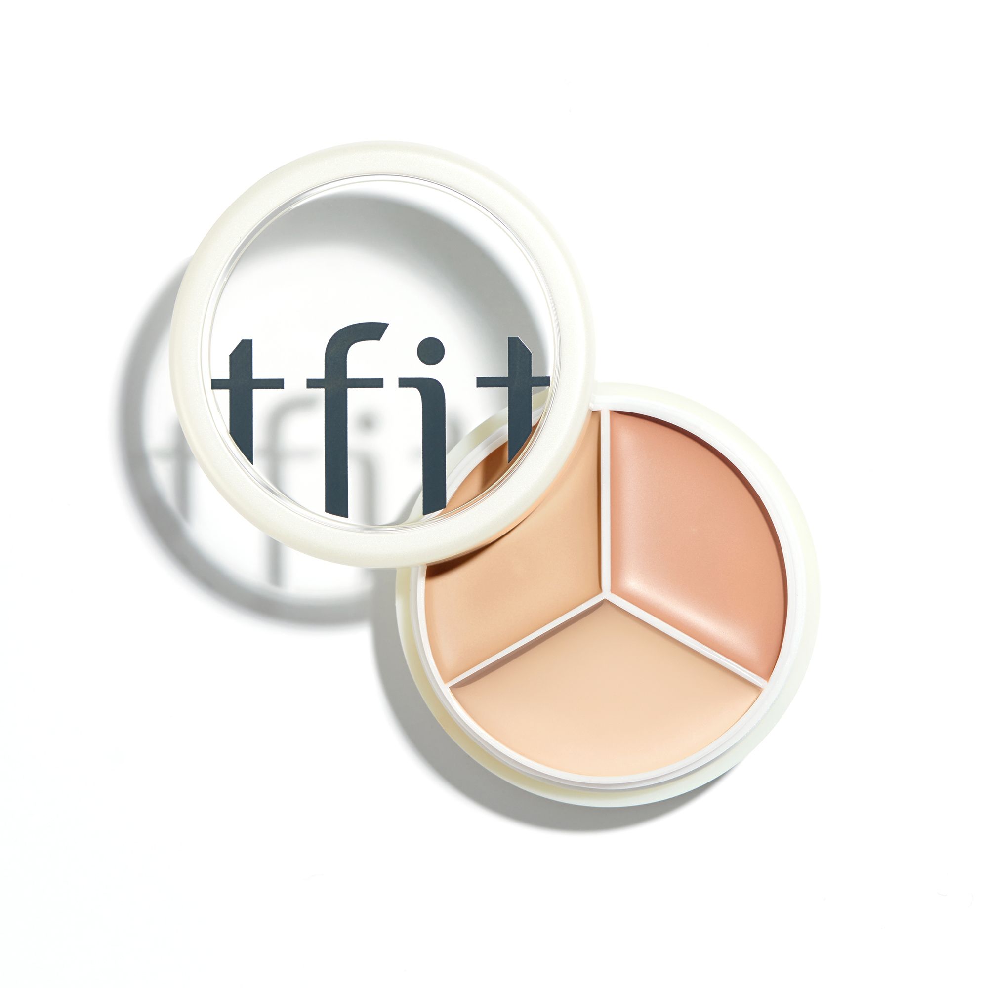Ronde concealer palette met drie tinten. Deksel met 'tfit' logo. Witte houder met transparante deksel.