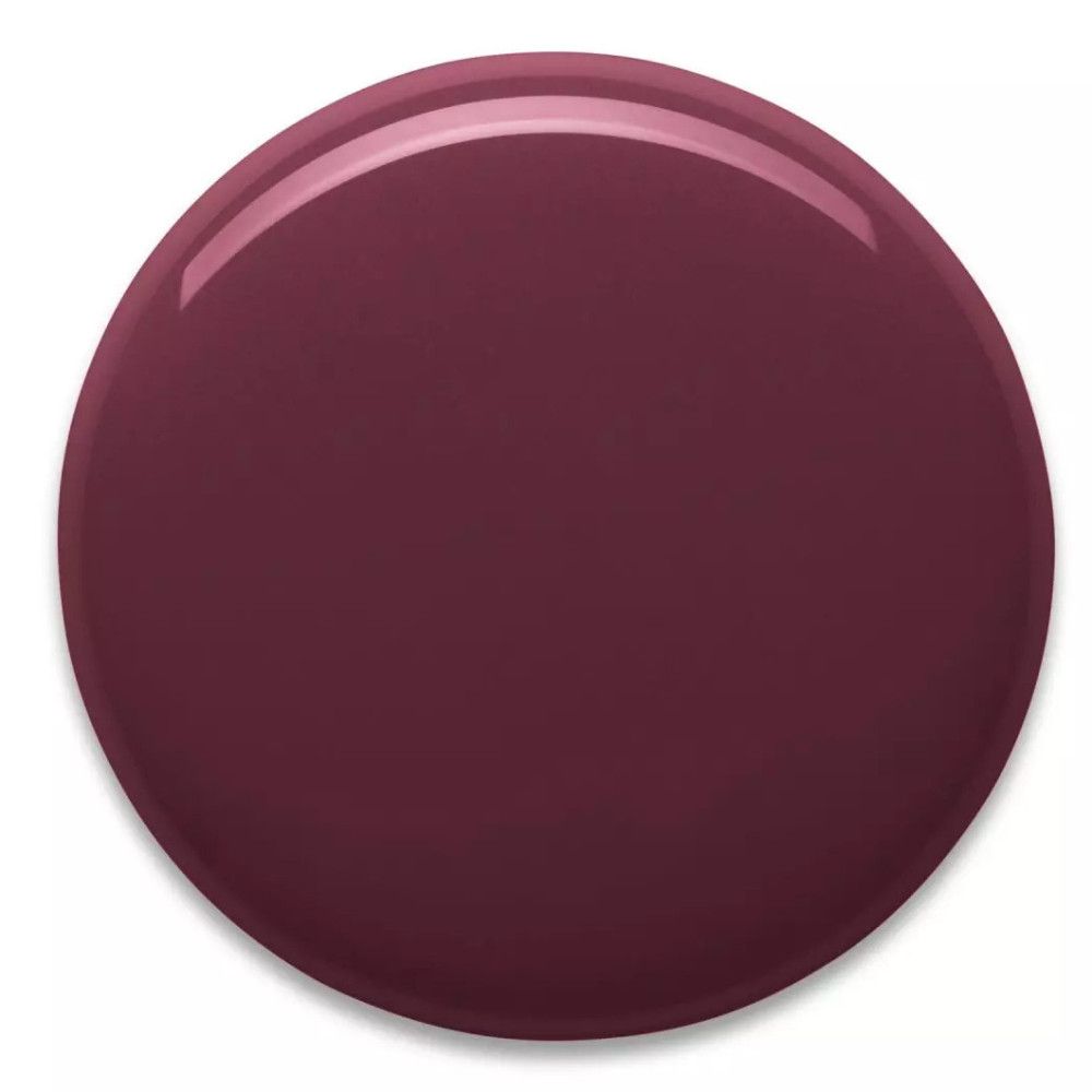 Tache ronde et brillante de vernis à ongles dans une teinte baie foncée.