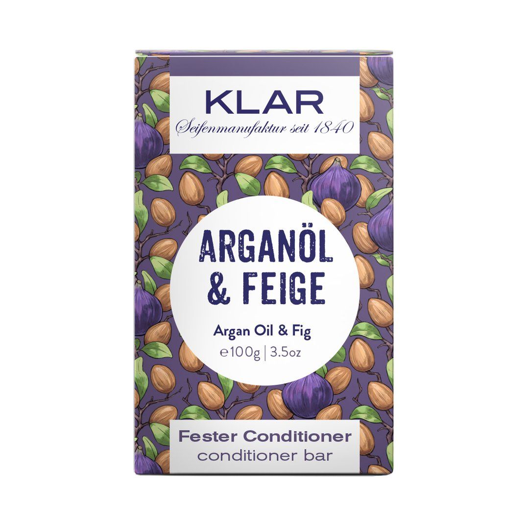 Klar-Seifen verpakking. Paarse achtergrond met Argan & Vijg. Tekst: Fester Conditioner, 100g/3.5oz.