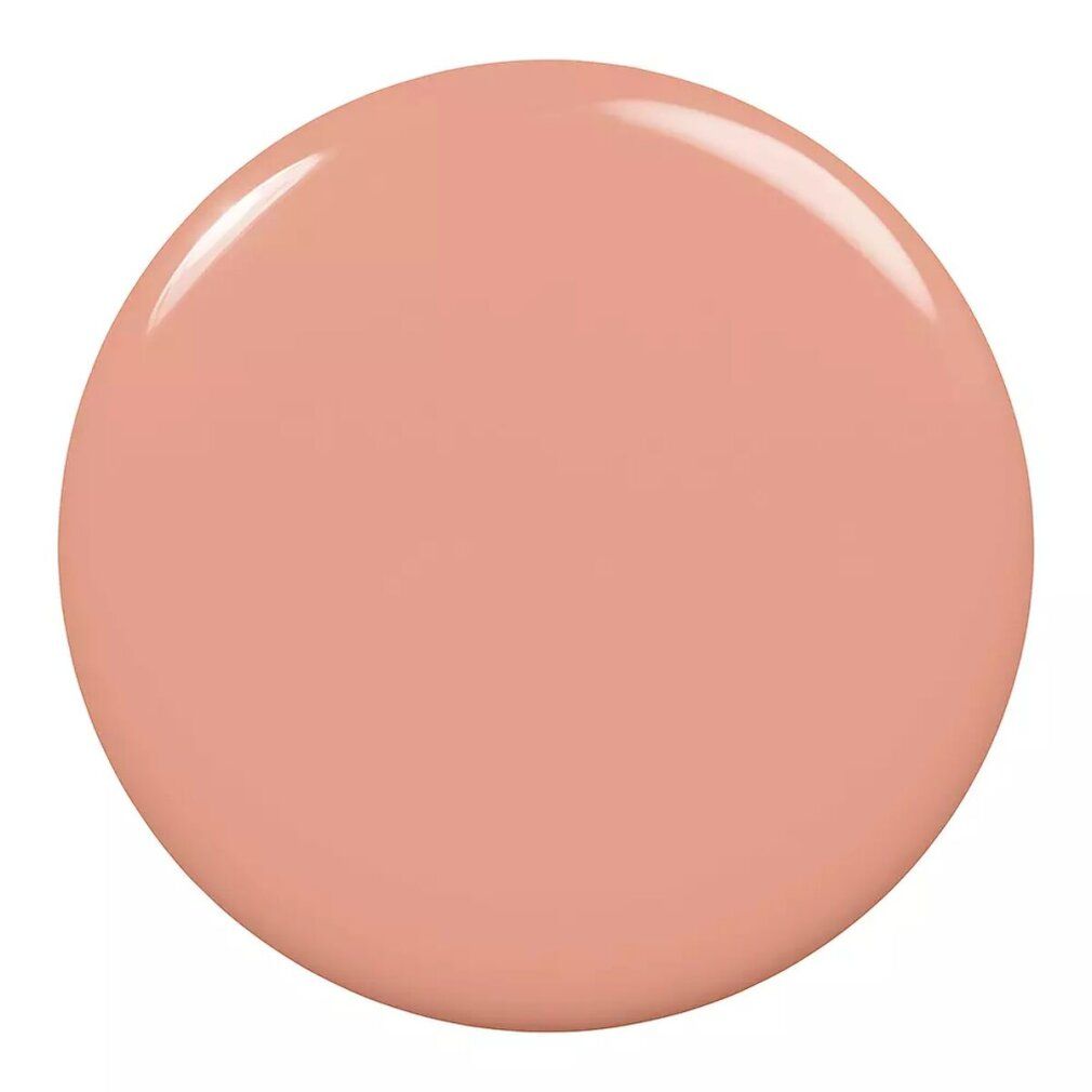 Tache ronde et brillante de vernis à ongles rose-beige. Pas d'emballage ni de flacon visible.