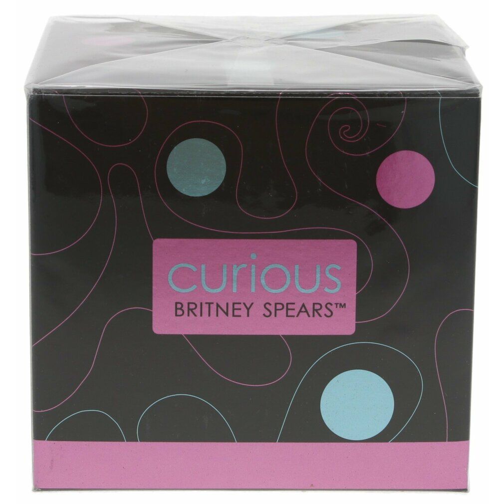 Boîte emballée avec l'impression "Curious Britney Spears". Fond noir avec cercles bleus et roses.