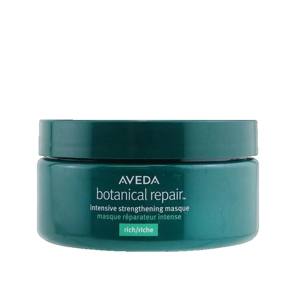 Ronde groene pot met deksel. Opschrift: Aveda, botanical repair. Tekst: intensive strengthening masque, rich/riche.