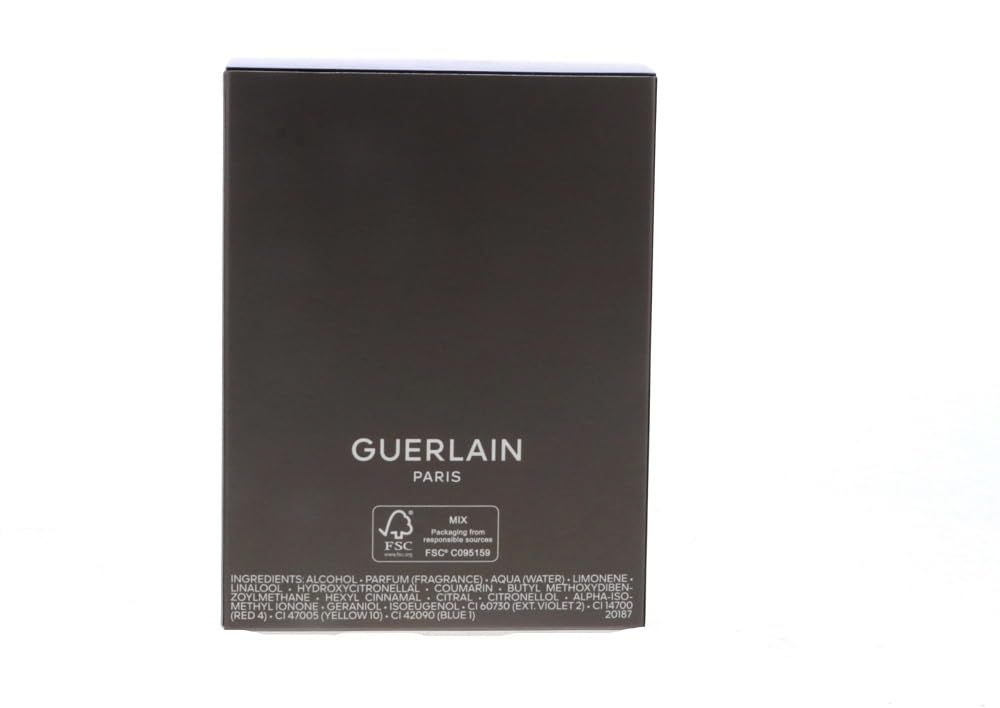 Emballage rectangulaire gris foncé. Inscription : Guerlain Paris. Certification FSC.