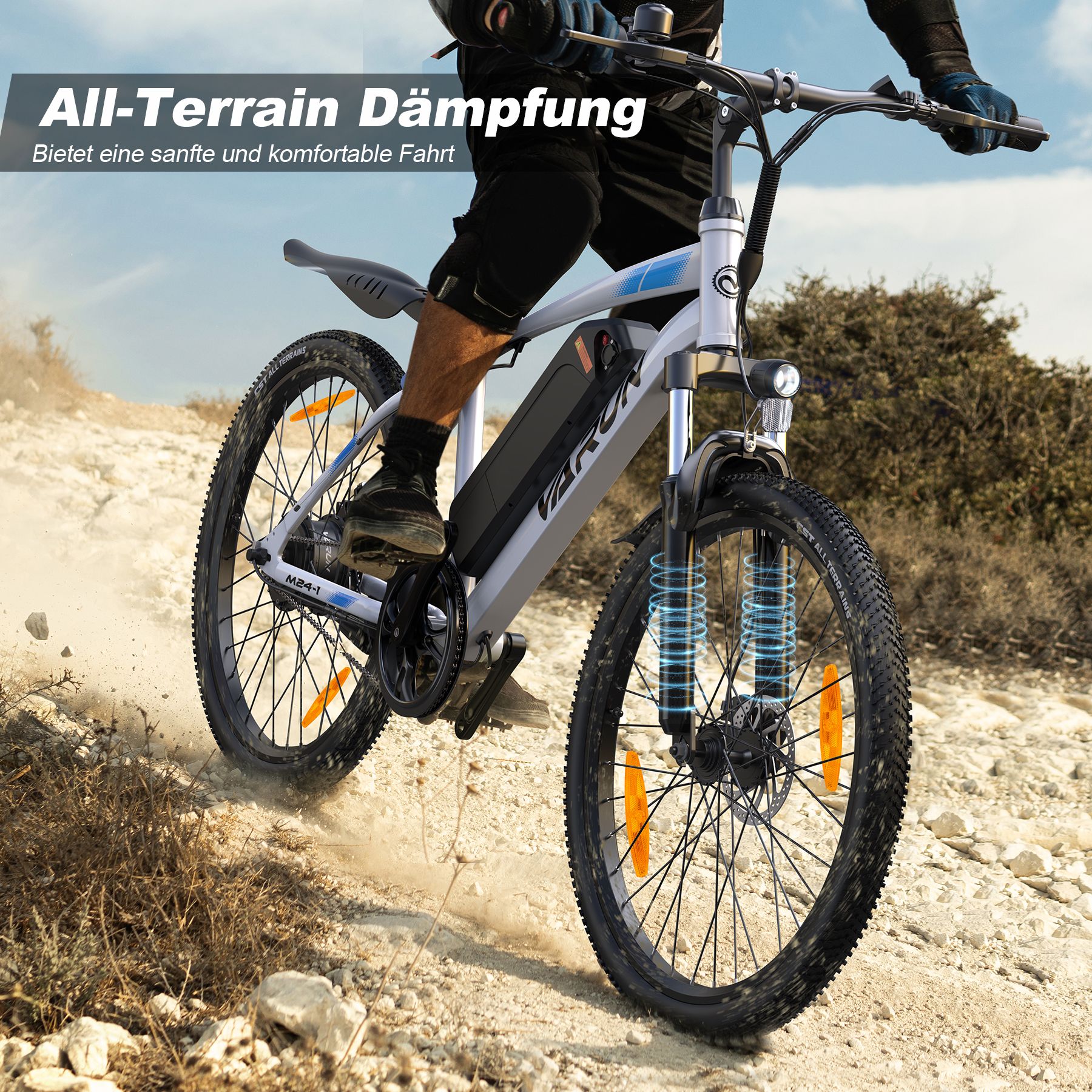 E-bike rijdt op oneffen terrein. All-Terrain demping. Witte e-bike met zwarte onderdelen. Fietser.