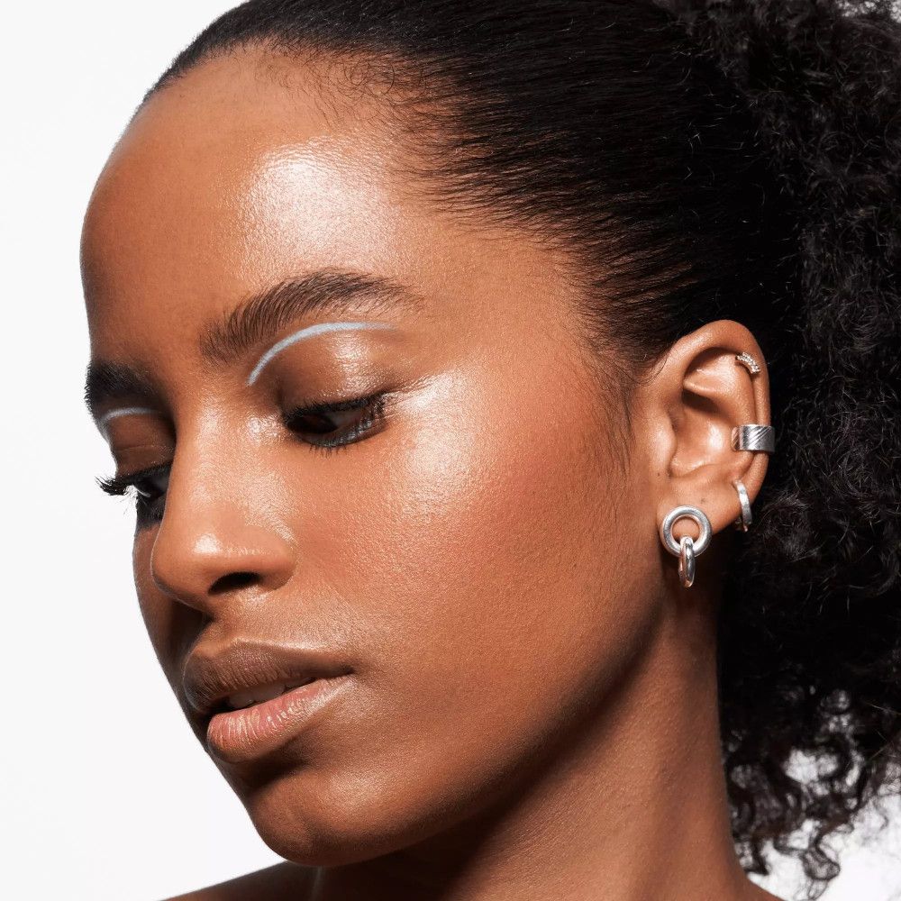 Gros plan d'une femme avec eye-liner blanc sur les paupières.