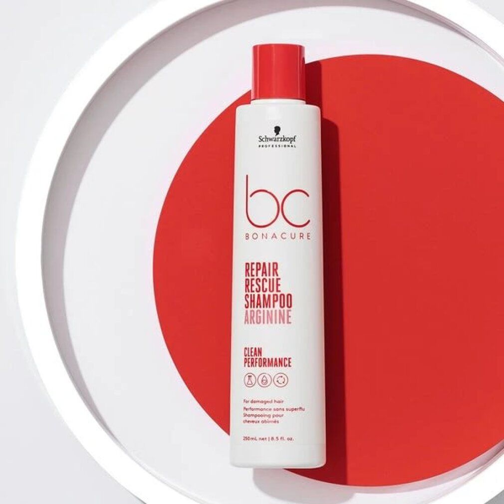 Witte shampoo met rode dop. Opschrift: BC Bonacure Repair Rescue Shampoo Arginine. Op rode cirkel.