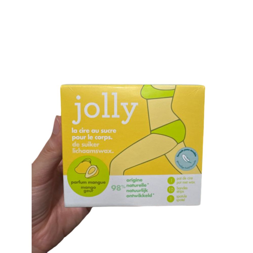 Gele verpakking met productnaam « jolly ». Illustratie van een vrouw. Tekst: « la cire au sucre pour le corps ». Mango geur. 98% natuurlijk.