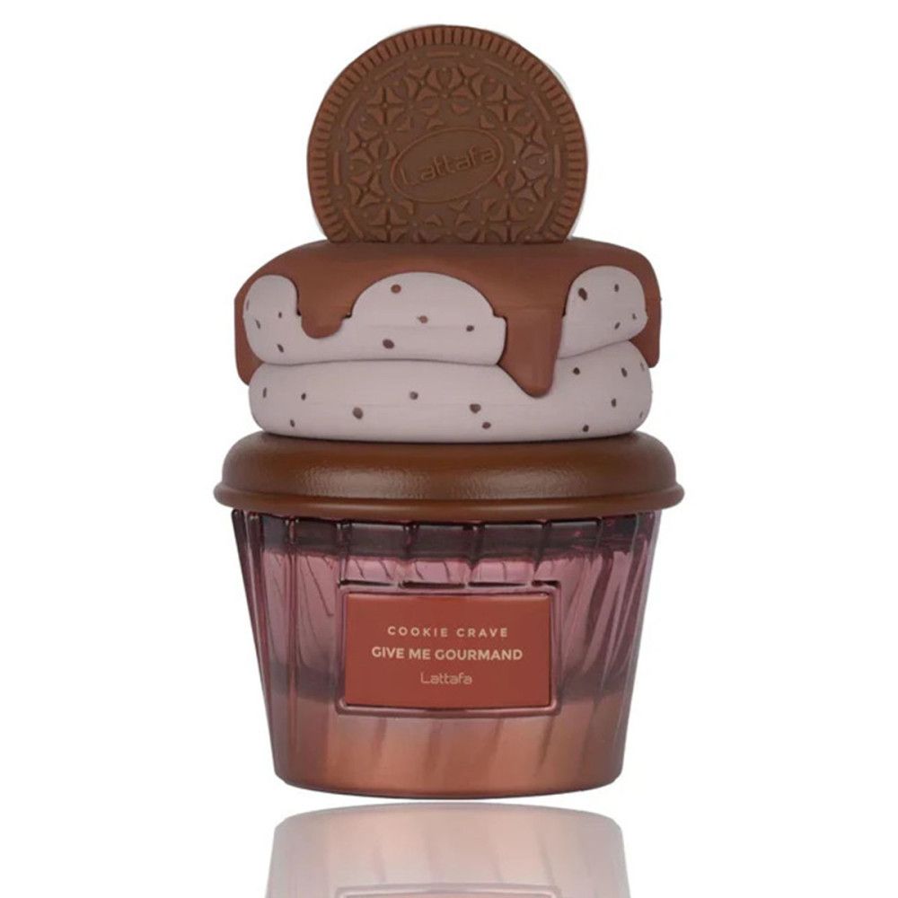 Flacon de parfum en forme de cupcake avec décoration biscuit. Nom du produit visible.
