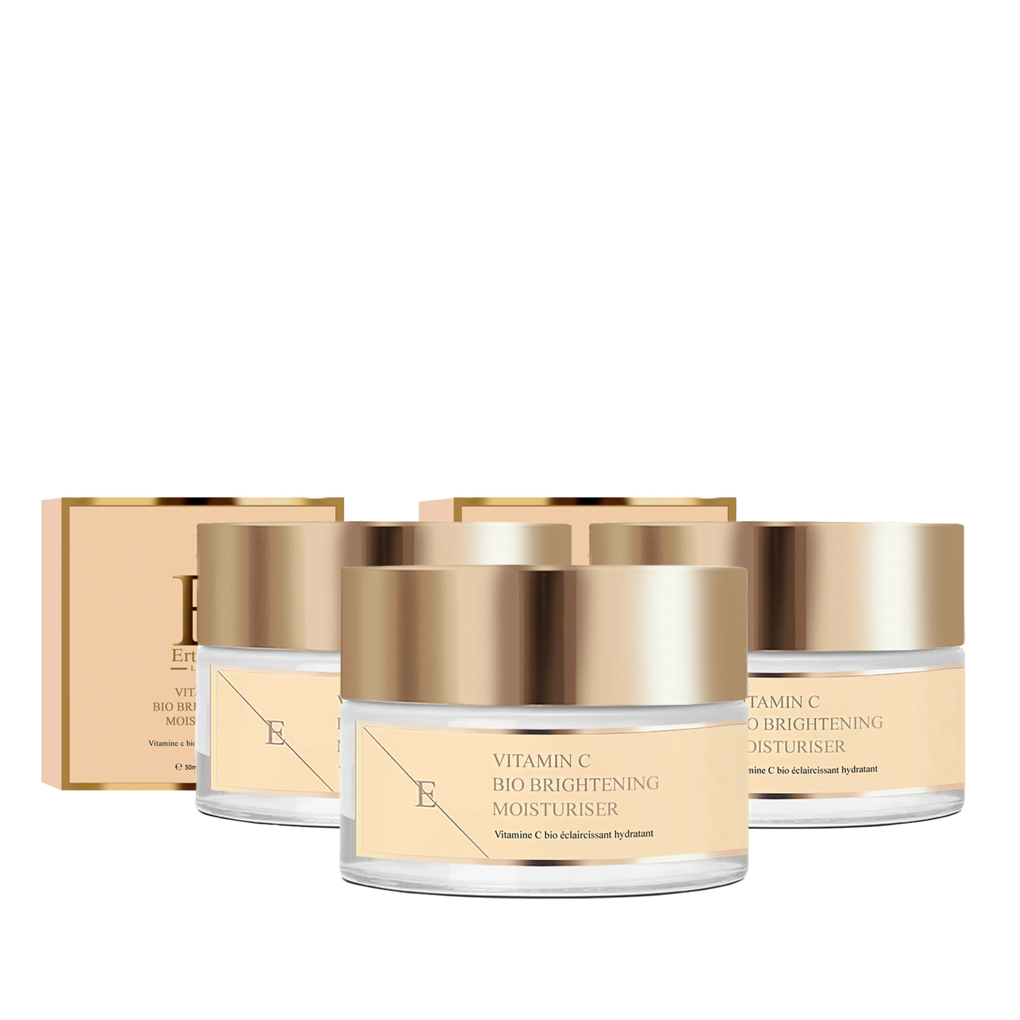 Trois pots avec couvercles dorés et un emballage. Les étiquettes indiquent : Vitamin C Bio Brightening Moisturiser.